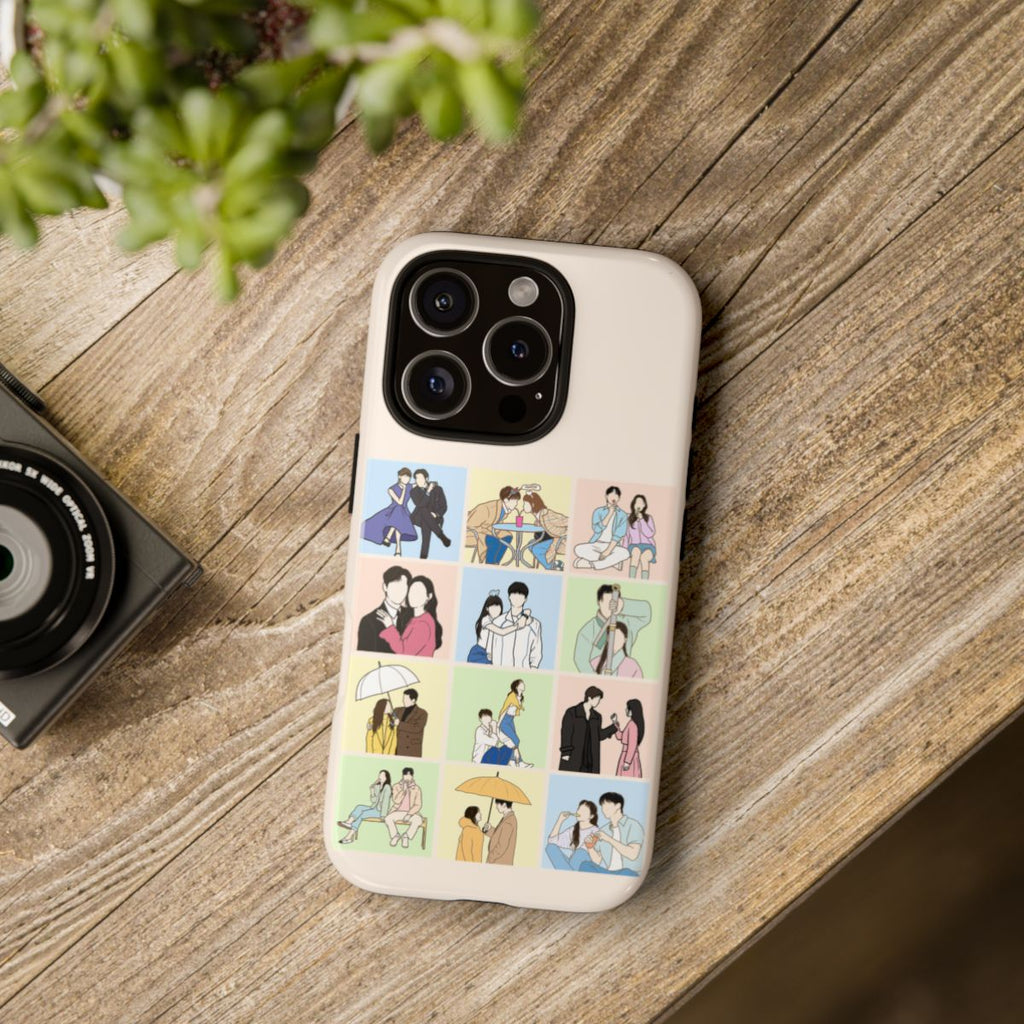 Kdrama collage fanart phone case on wooden table – cream-colored case featuring illustrated romantic Korean drama scenes in pastel blocks