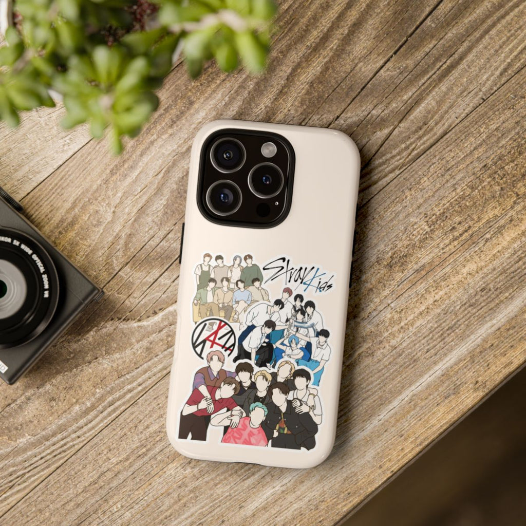Stray Kids collage fanart phone case on wooden table – cream-colored case featuring illustrated Kpop group scenes and SKZ logos for STAYs